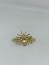 Prendedor dorado con negro de metal de abeja